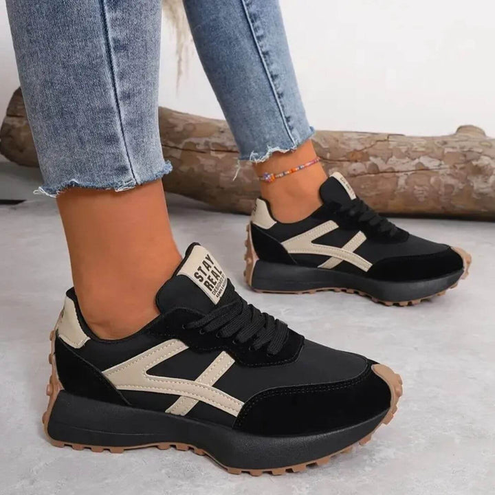 Reeve retro runner sneakers black-beige colorway styled with casual outfit, lifestyle shot