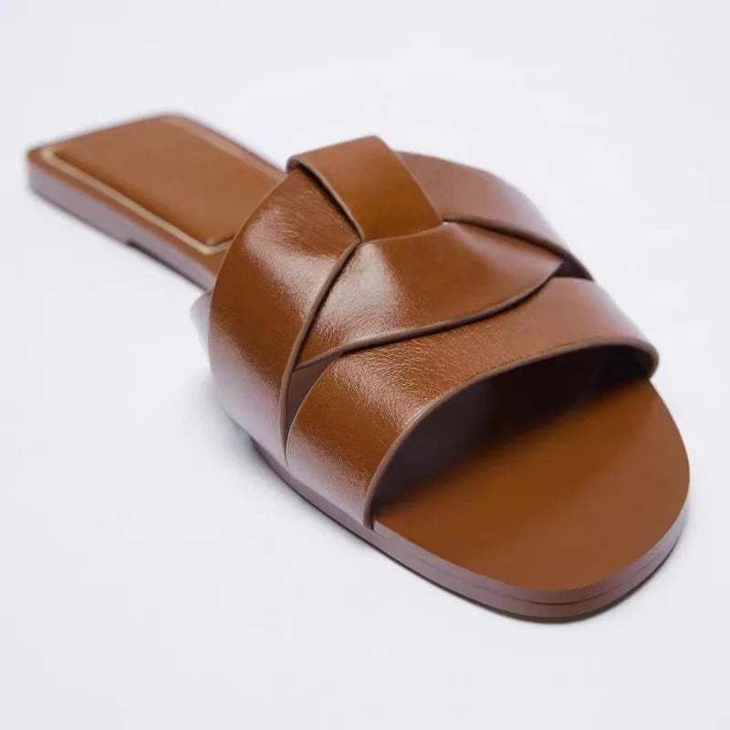 Side view of Ridge women's slides in brown showing lightweight flexible sole and sleek minimalist silhouette