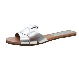 Ridge women's cushioned slides in beige styled with linen trousers on a light background