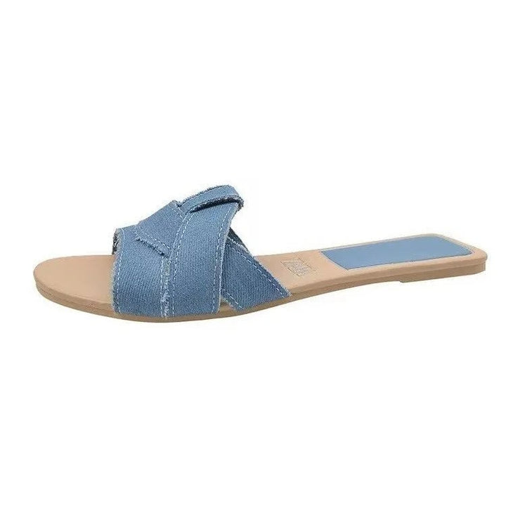 Pair of Ridge slides in classic black flat lay on a white surface
