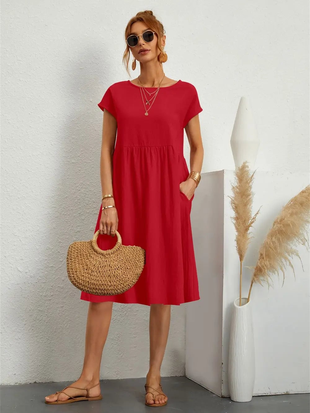 Woman wearing a relaxed casual pocket dress in a neutral color, styled with simple accessories for an everyday look