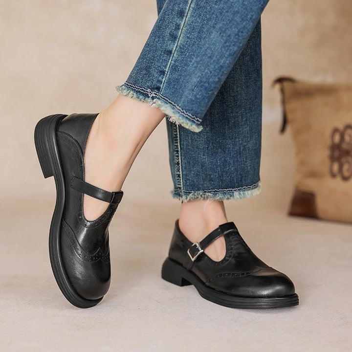 Rosie leather T-strap Mary Jane shoes in black with brogue wingtip detailing and low block heel, front view