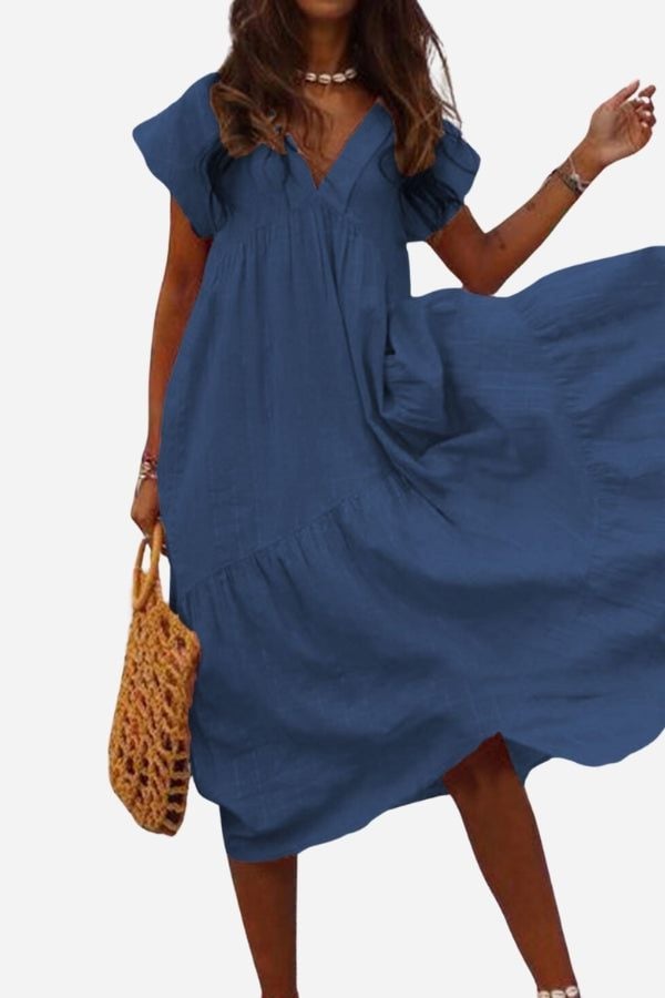 Rosie tiered midi dress in light blue worn by a woman in a bright outdoor setting