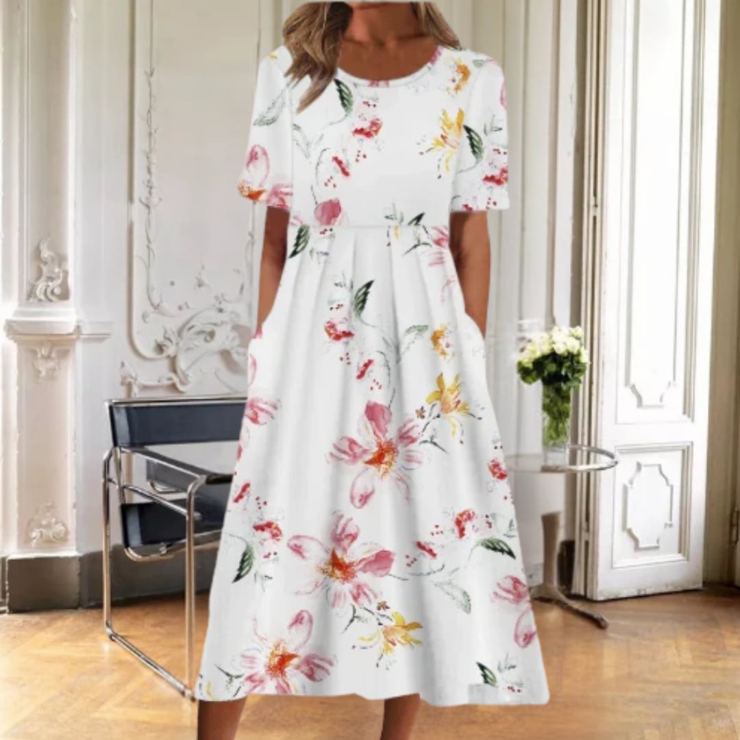 Flat lay of multiple Ruby floral midi dress color options including pink blossom and blue and yellow floral prints