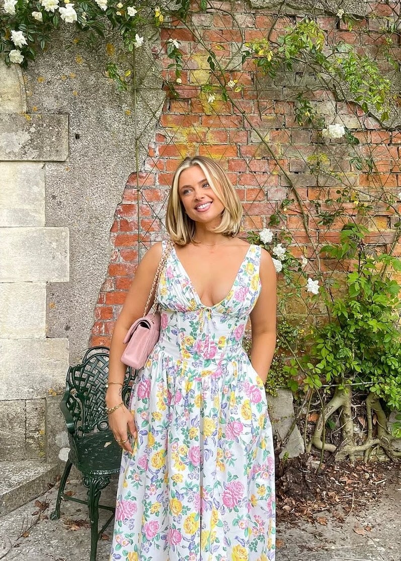 Full-length shot of model in the Saffron peach dress styled with strappy sandals for a summer occasion