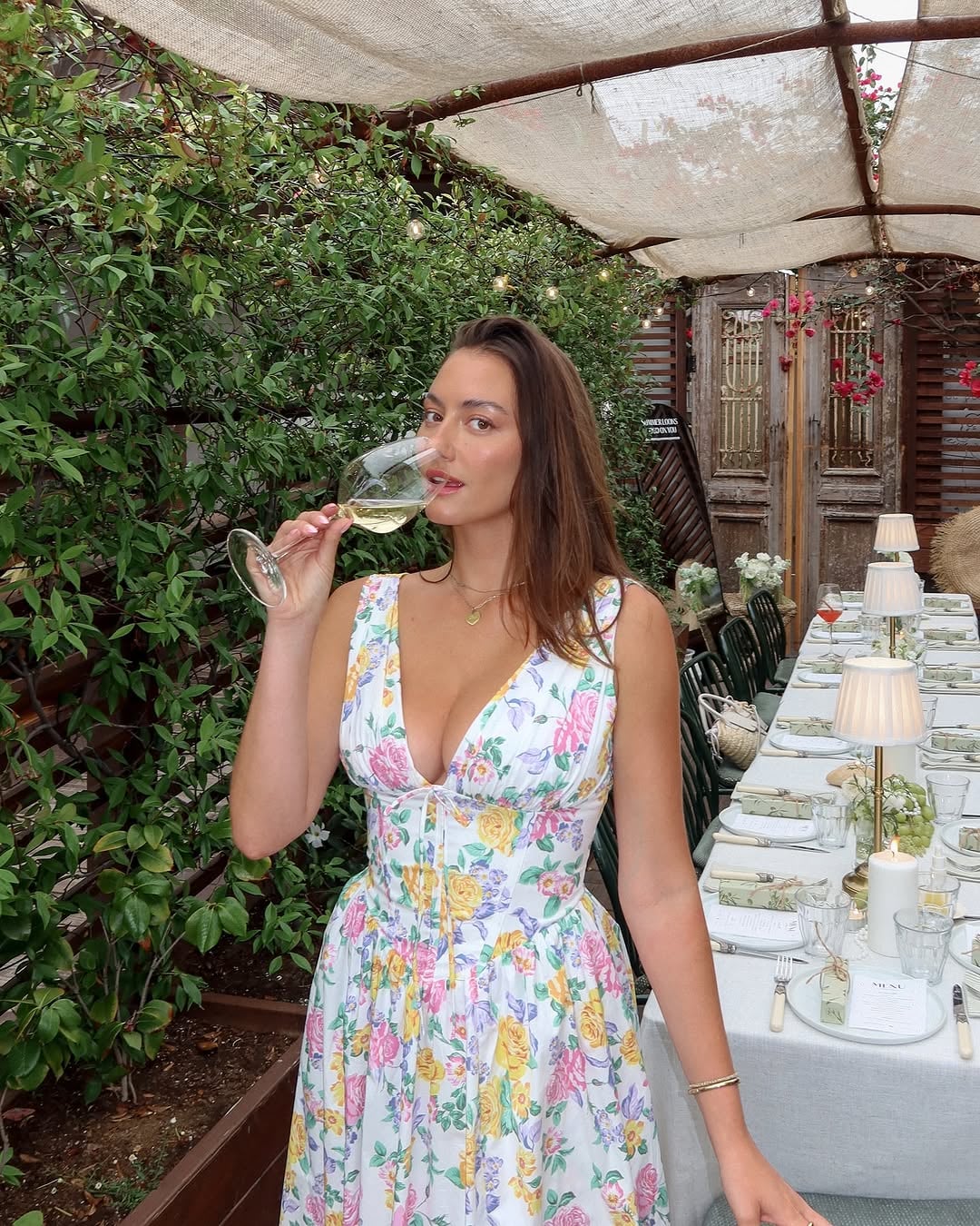 Model wearing the Saffron pink floral dress outdoors in natural light, styled for a garden wedding