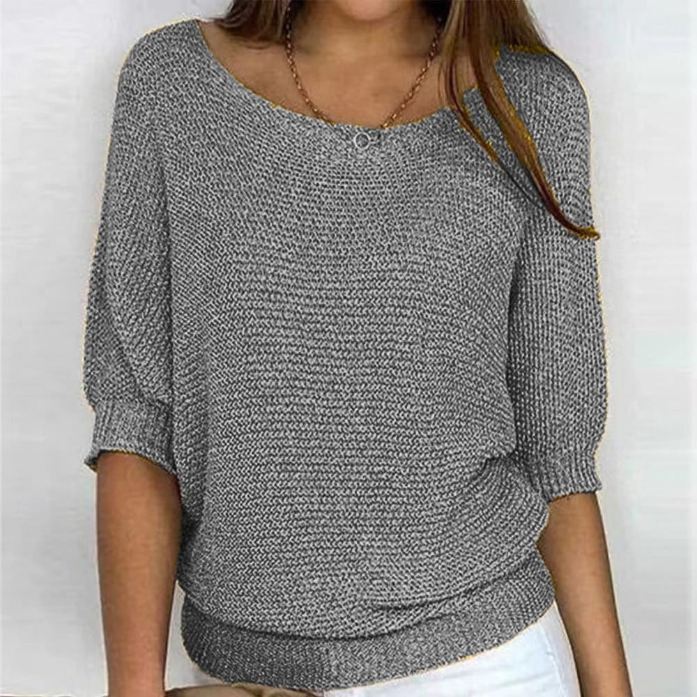 Woman wearing the Scarlett elegant all-season sweater in a soft neutral color, styled with jeans for a polished casual look