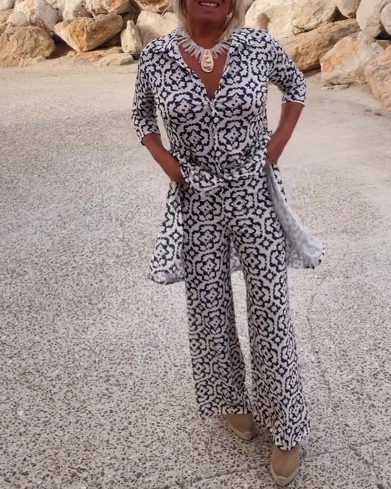 Woman wearing the Serena two-piece set in green with matching printed blouse and slim pants