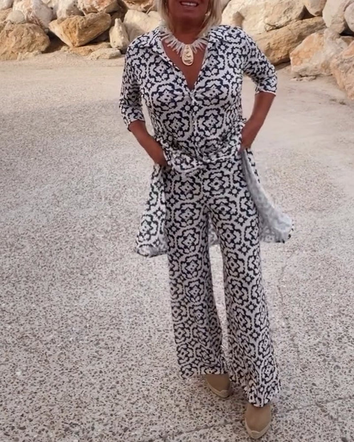 Woman wearing the Serena two-piece set in green with matching printed blouse and slim pants