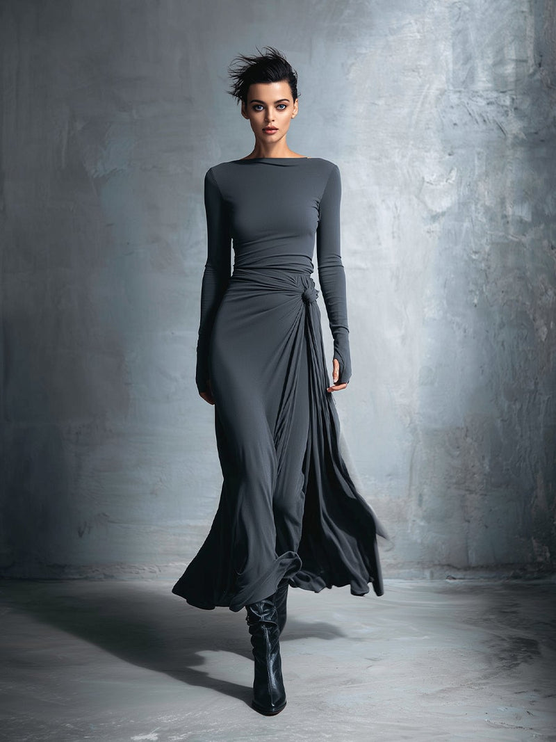 Woman wearing a grey wrap maxi dress with a flowing silhouette and adjustable waist tie