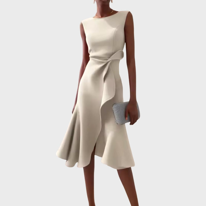 Model smiling in the draped asymmetric midi dress, showing the overall silhouette
