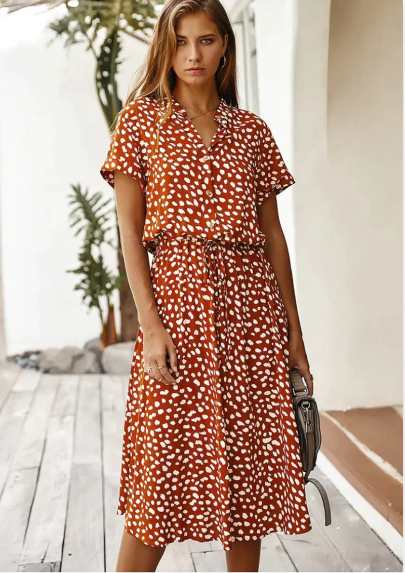 Model wearing spotted print midi dress in green with strappy sandals, full-length front view