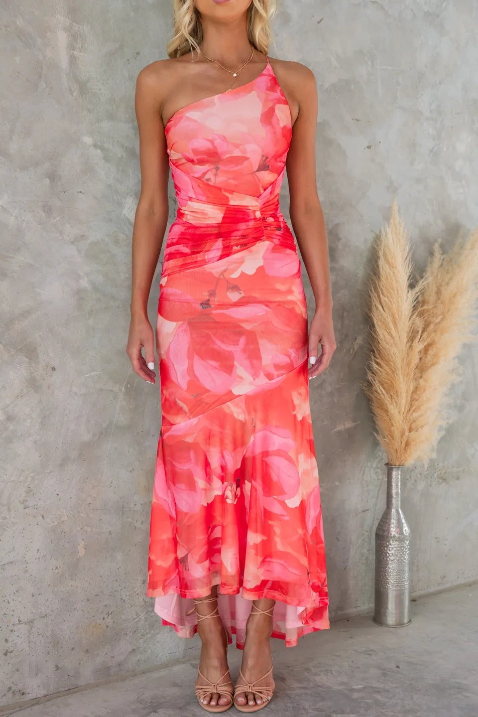 Model styled in the Solange floral dress in blue paired with strappy sandals for a wedding guest look