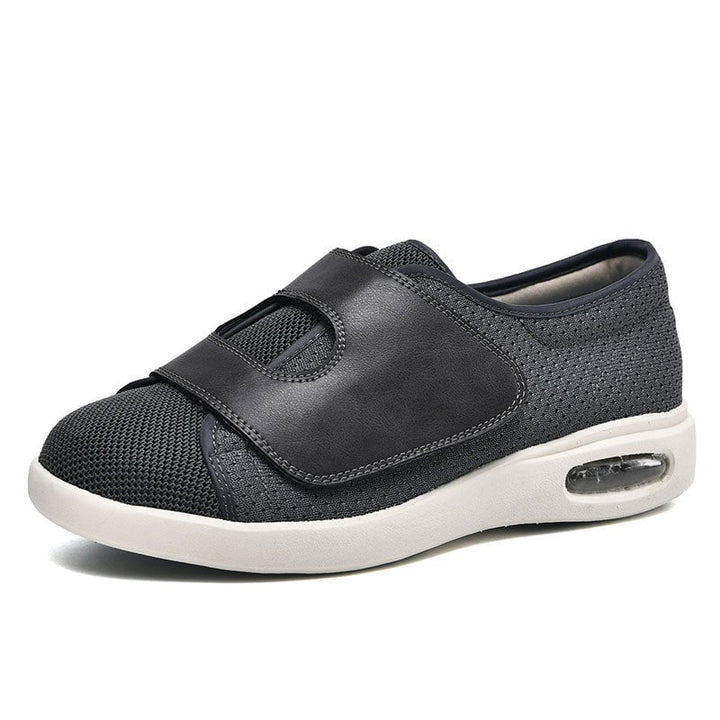 Side profile of women's wide fit knit sneaker highlighting the adjustable hook-and-loop strap closure