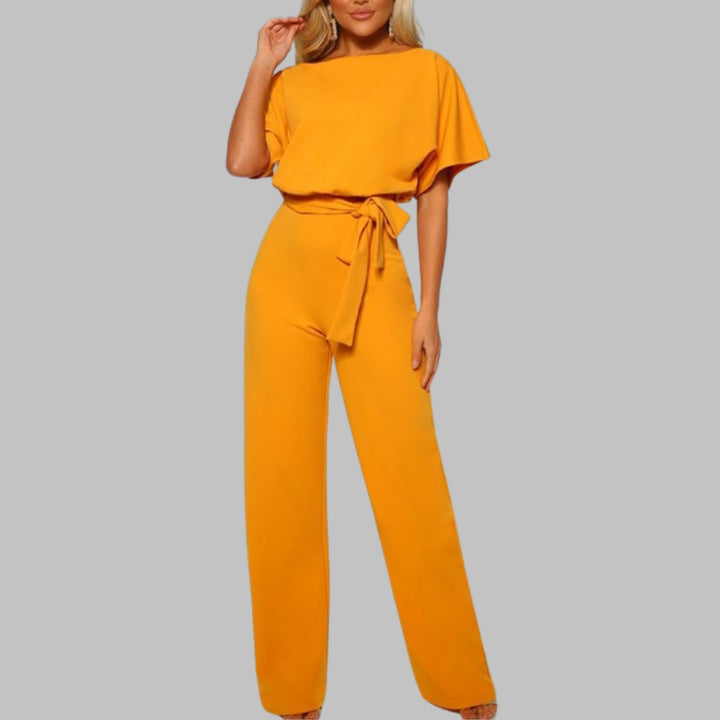 Woman wearing a yellow belted wide-leg jumpsuit with batwing sleeves and a self-tie waist belt