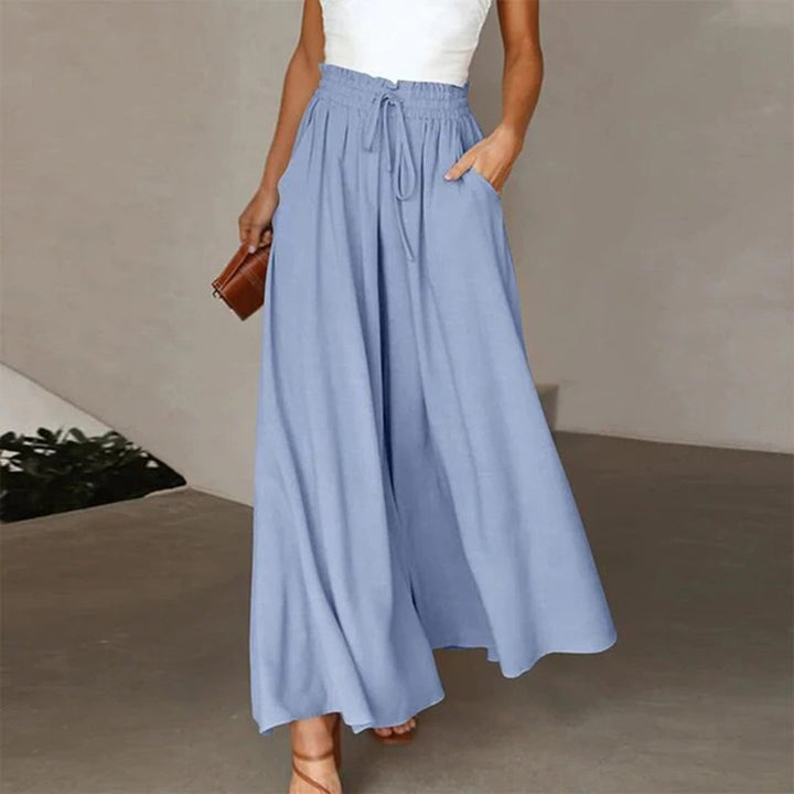 Model wearing Terra wide leg pants paired with a fitted white top and sandals