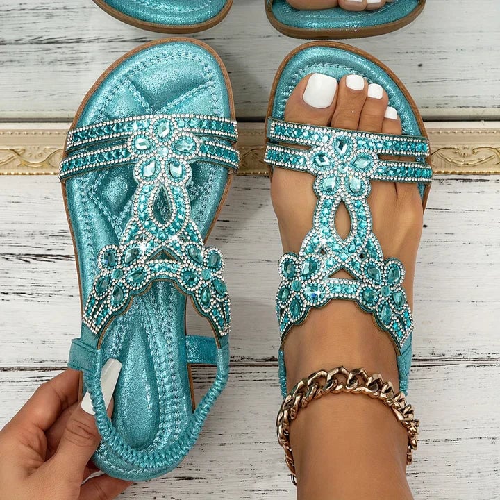 Flat lay of all six Thea sandal color options: blue, silver, black, white, khaki, and gold