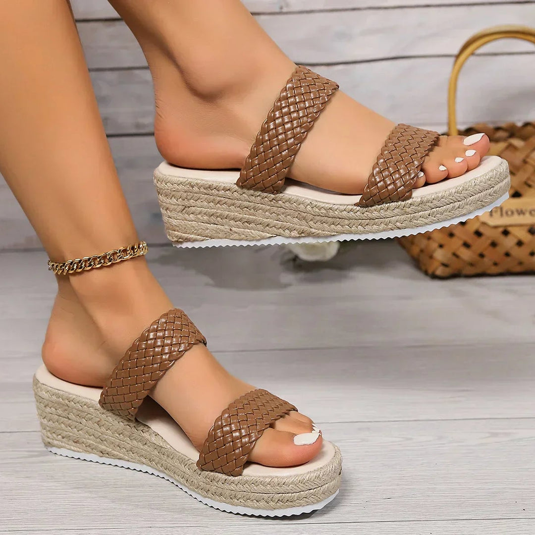 Theodora wedge sandals in brown on a neutral background, three-quarter view