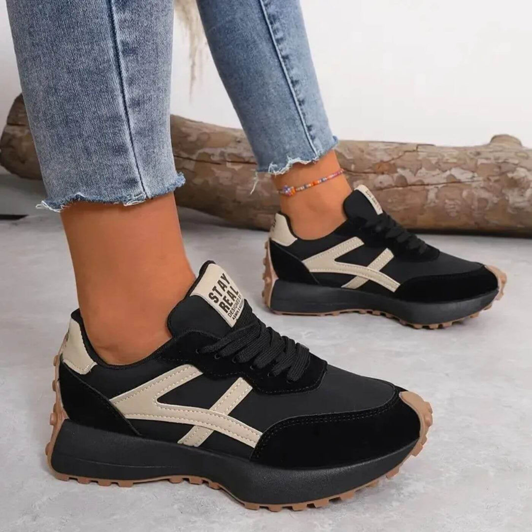 Front view of slip-resistant orthopedic sneakers in neutral colorway showing cushioned sole and breathable upper