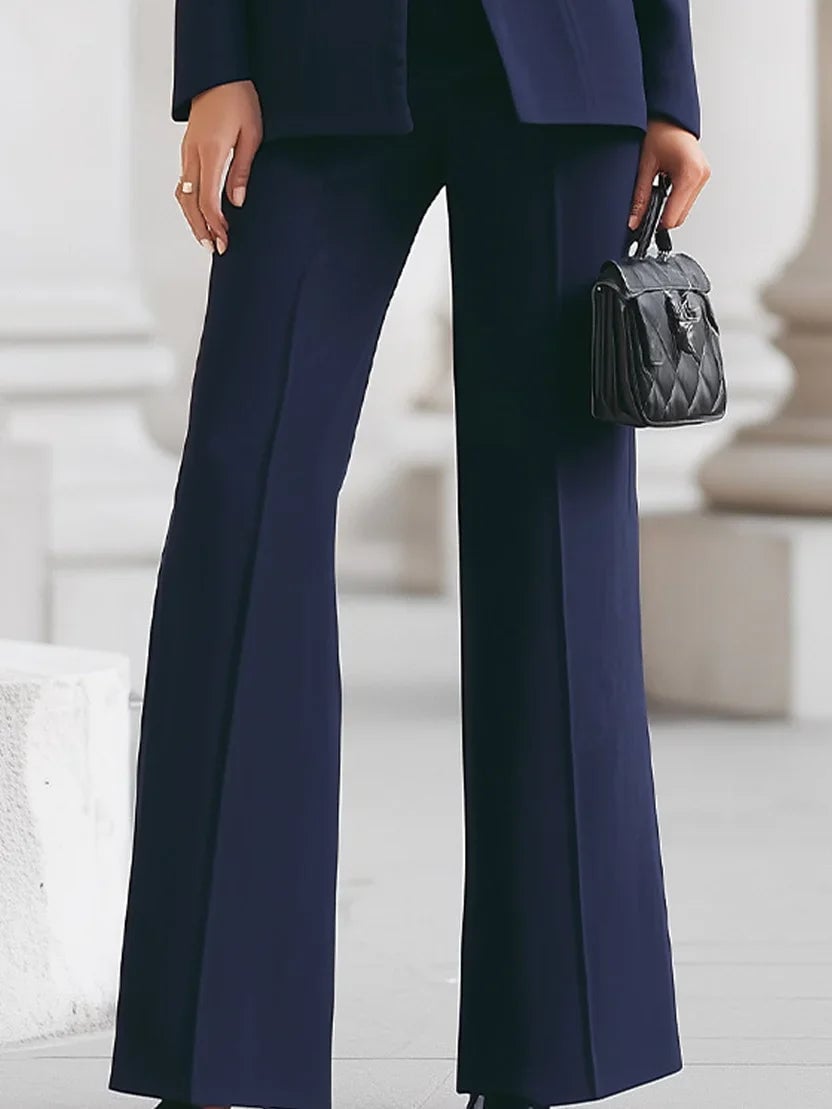 Full-length view of the Vina two-piece set in red demonstrating the flare trouser silhouette