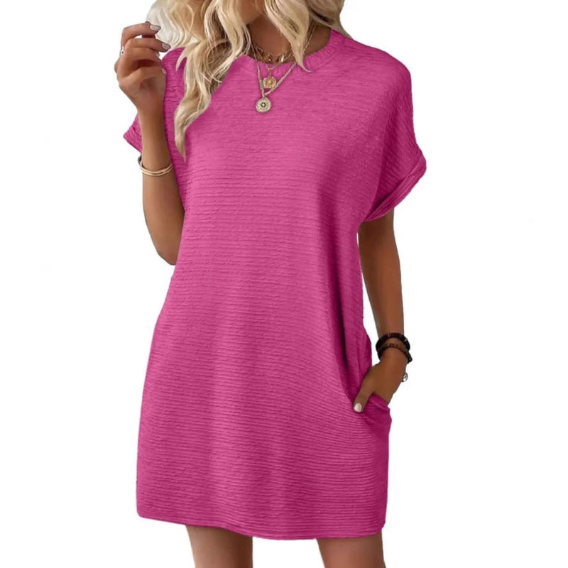 Woman wearing the Vivid ribbed crew neck mini dress in Rose Red with cuffed short sleeves and side pockets