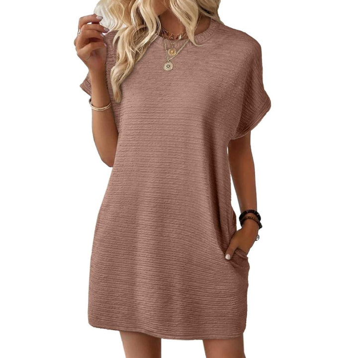 Woman wearing the Vivid mini dress in Light Brown with white sneakers for a casual daytime look