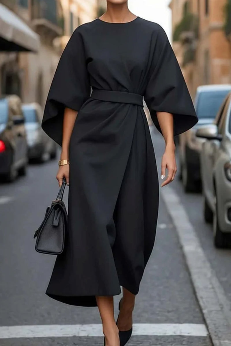 Woman wearing the Wendy elegant lantern sleeve dress in blue with an adjustable waist bow, flowing silhouette