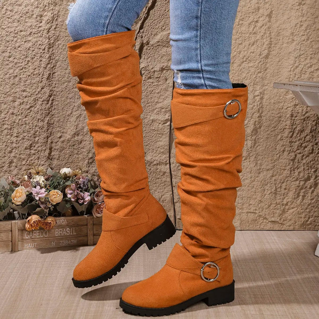 Flat lay of Wyn knee high boots in multiple color options including blue and orange