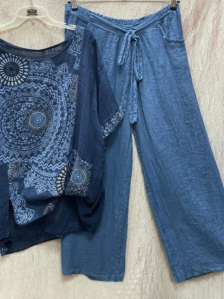 Side view of model in the Zahara blue mandala print wide-leg pants and matching top highlighting the flowing leg silhouette