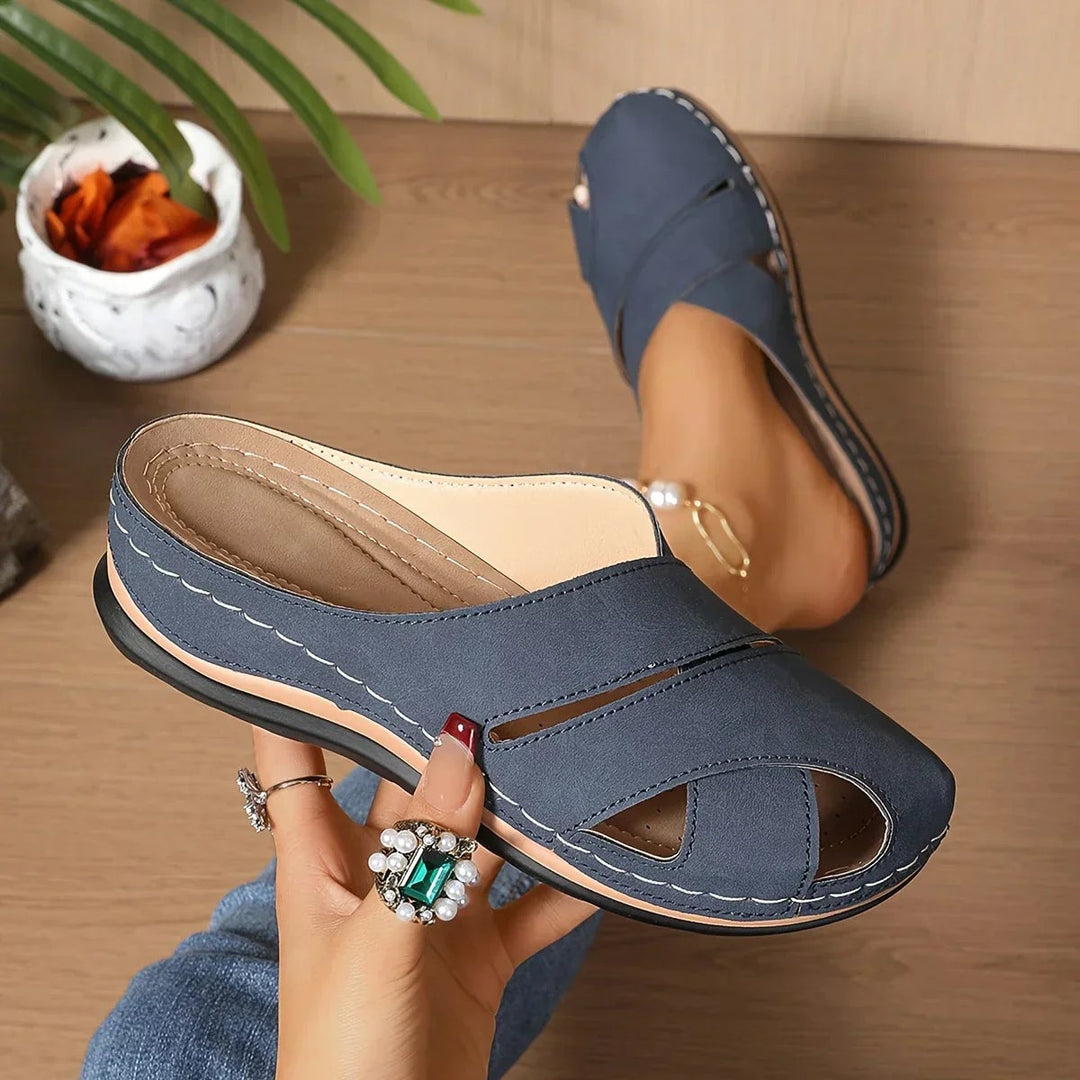 Close-up of cushioned insole and secure ankle strap on women's platform wedge sandals