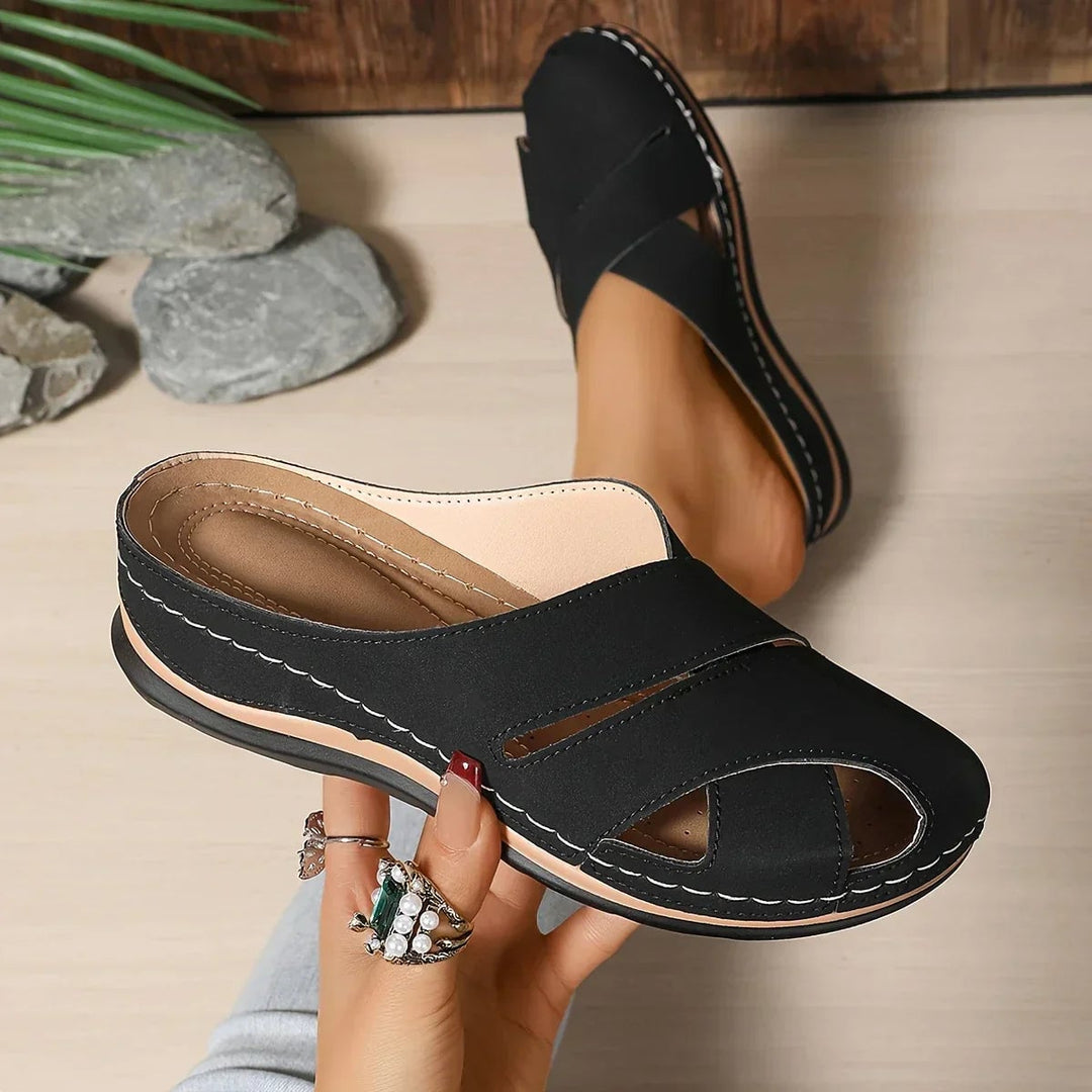 Women's platform wedge sandals in blue worn on feet showing leg-lengthening silhouette