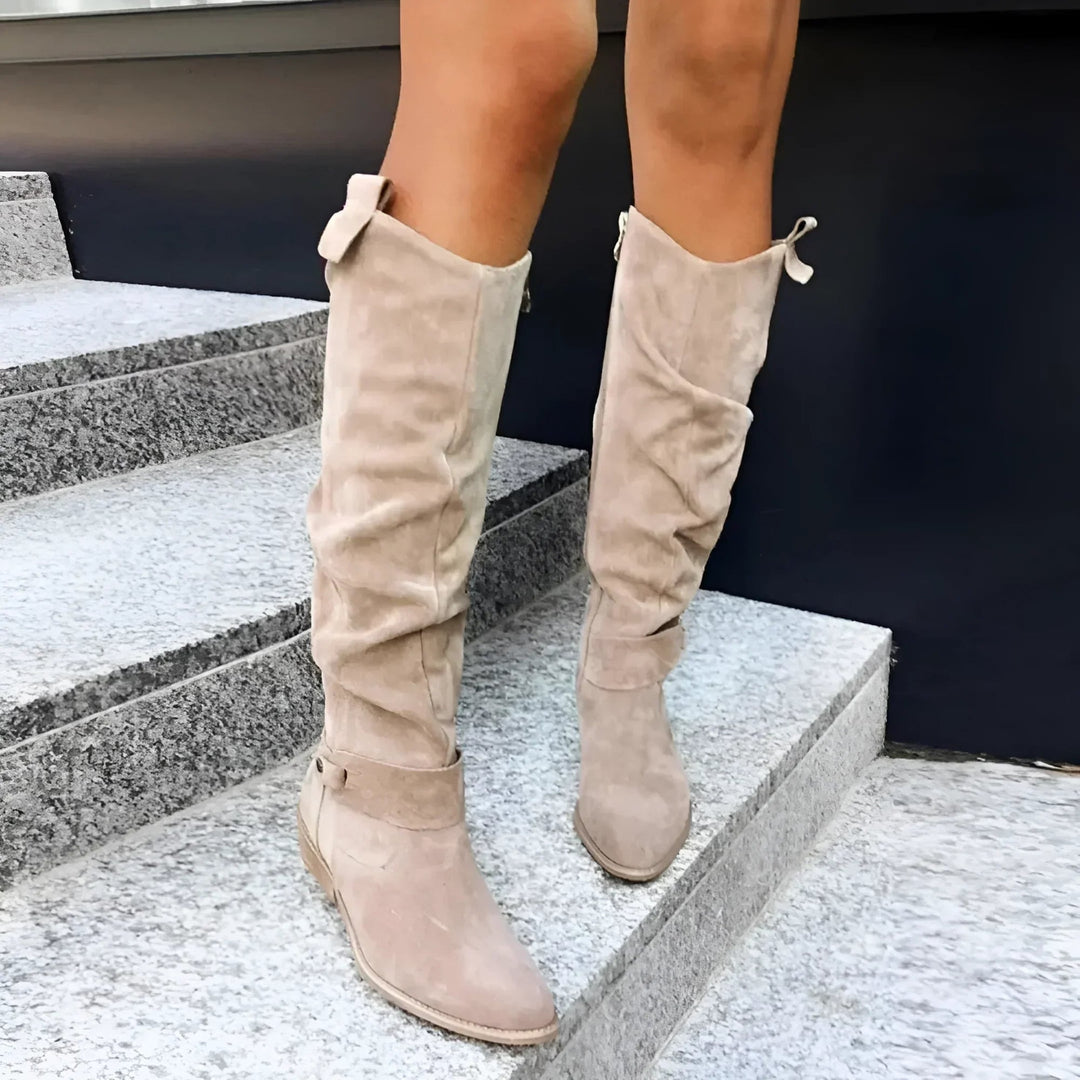 Pair of suede knee-high boots in beige and black displayed side by side